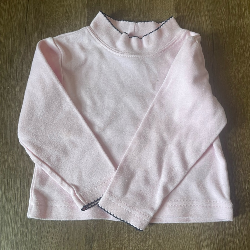 Light pink turtleneck with black trim